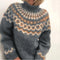 Gray knitted sweater with a pattern on a white background